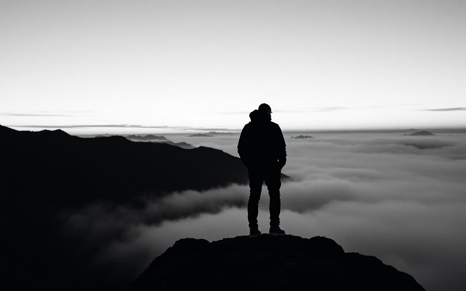 A solitary hiker on an Australian ridgeline carrying outdoor equipment